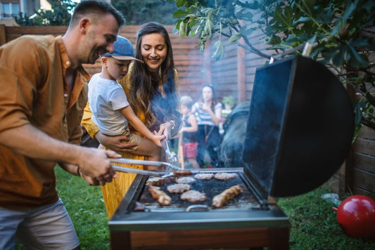 dad grilling steak with engraved cutting board